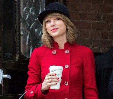 Taylor Swift in a hat holding a Starbucks cup to show Taylor Swift lyrics for fall-inspired Instagra...