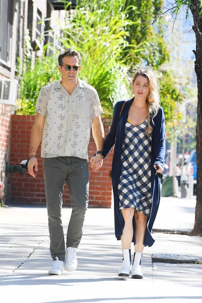 Blake Lively wearing white Chelsea boots while walking with Ryan Reynolds.
