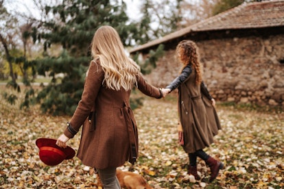 Two young women holding hands surrounded by fall leaves in need of November captions and quotes for ...