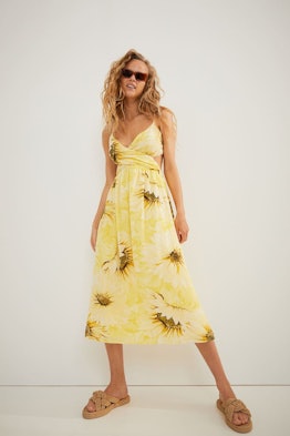 Model in a yellow, sunflower print dress from H&M.