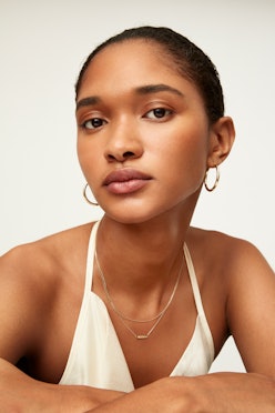 Model wears Mejuri earrings and necklaces.