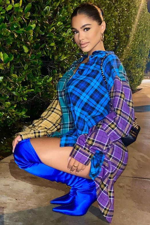 Model wearing Fashion Nova's flannel shirt and knee high boots.