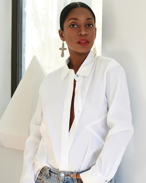 Rajni Jacques wearing a white button-down and jeans.