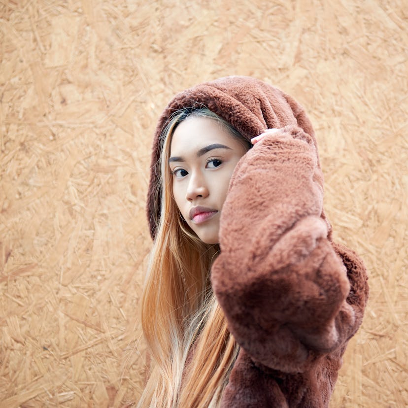 Young woman in a brown hoodie at the end of fall 2021, most affected by winter solstice 2021, per he...