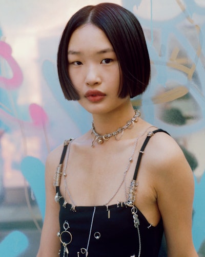 Model wears Justine Clenquet's silver and gold necklaces and earrings.