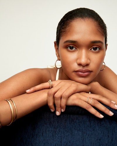 Model wears Mejuri rings, earrings, and bracelets.