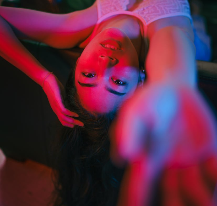 Young woman reaching out during the December 2021 full moon in Gemini, which will have a deep emotio...