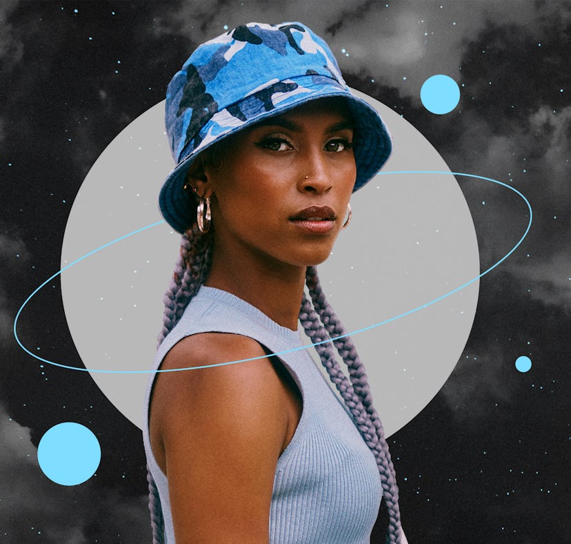 Young woman wearing a blue hat before reading her December 2021 monthly horoscope.