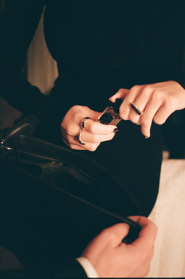 Camilla Morrone's hands holding a nail polish bottle