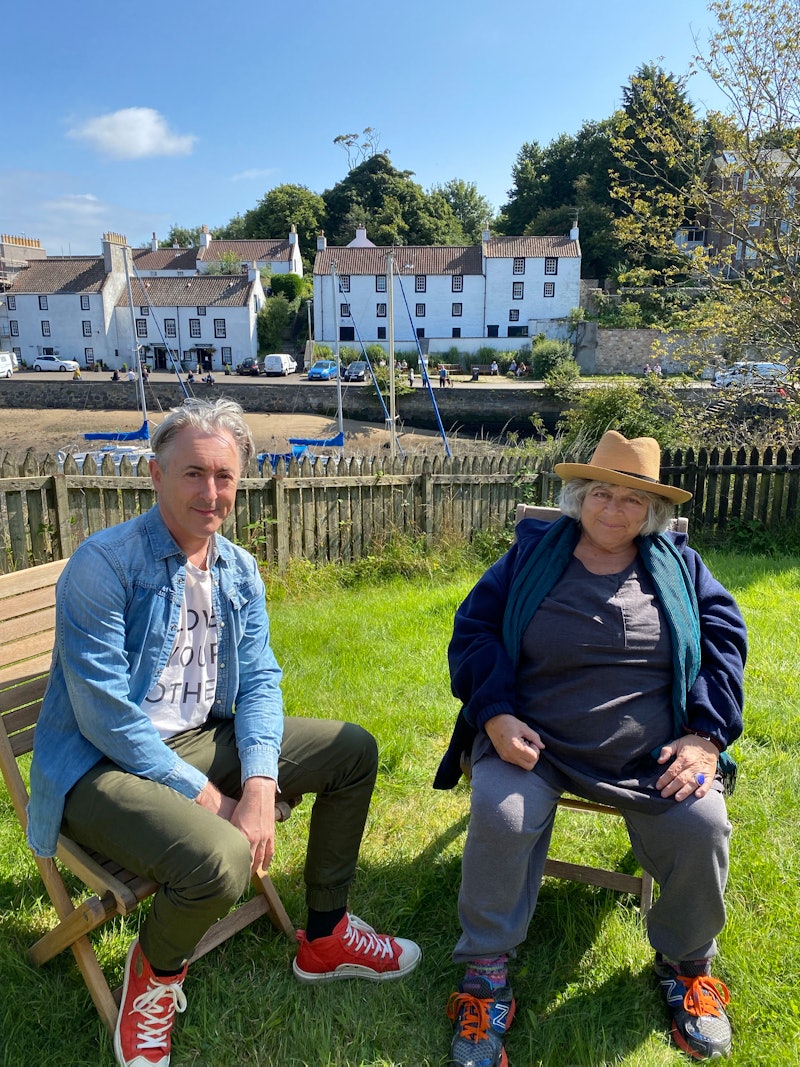 Alan Cumming And Miriam Margolyes pictures sitting on chairs in front of a scenic harbourside backdr...