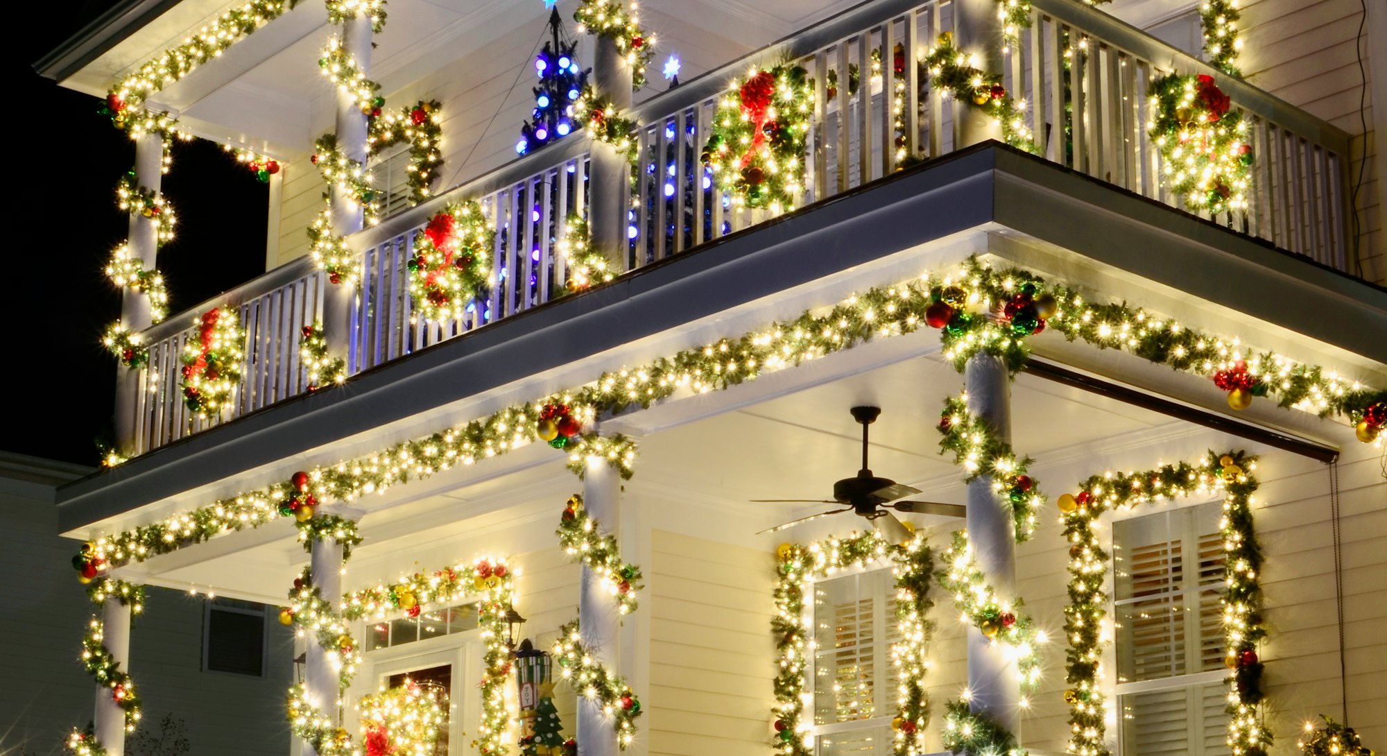 the most beautiful christmas towns in america go all out with christmas lights like this victorian h...
