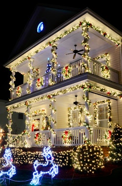 the most beautiful christmas towns in america go all out with christmas lights like this victorian h...