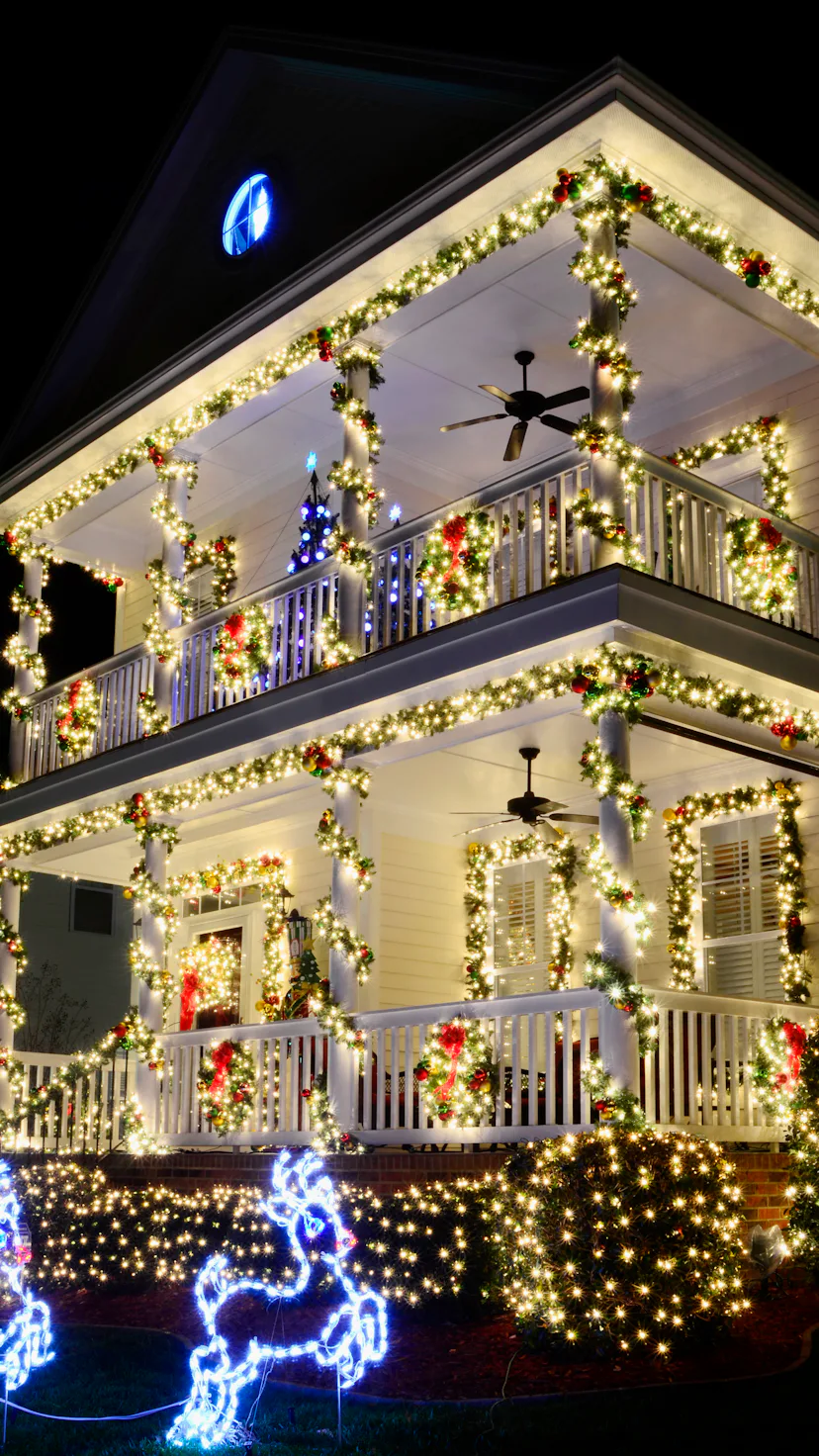 the most beautiful christmas towns in america go all out with christmas lights like this victorian h...
