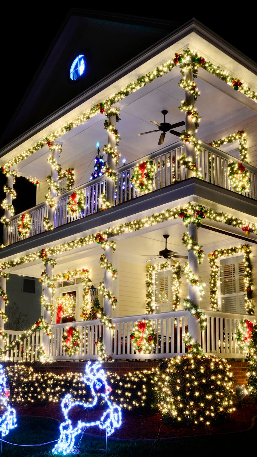 the most beautiful christmas towns in america go all out with christmas lights like this victorian h...