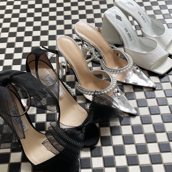 Three pairs of festive party heels from, including black bow heels, silver embellished pumps, and wh...