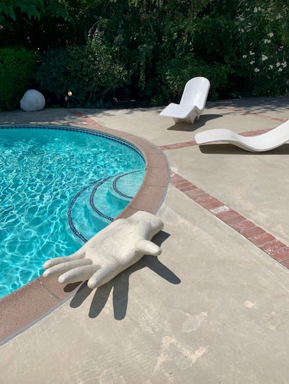 Chelsea Hansford's Los Angeles Home with a pool and a hand sculpture seat