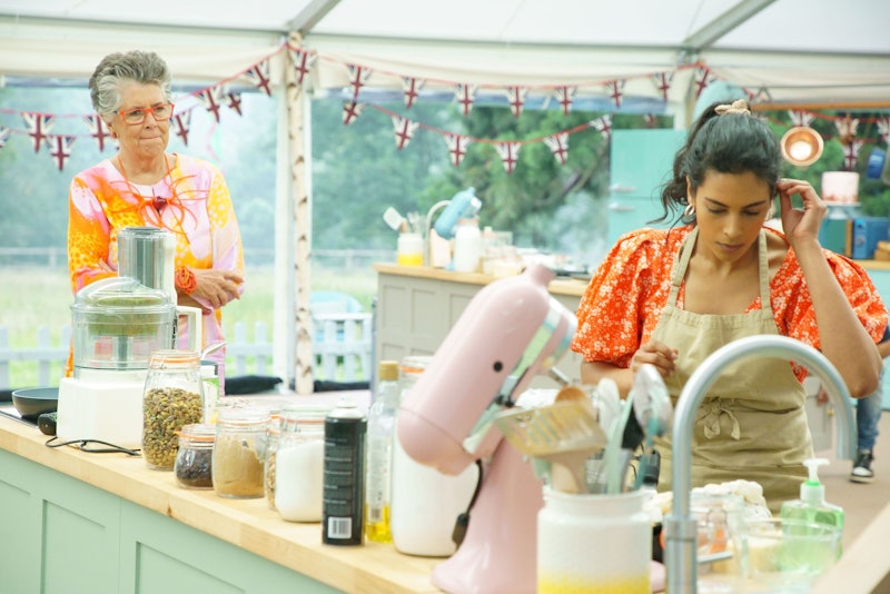 Bake Off judge Prue Leith looks on as contestant Crystelle looks over her baking bench at some ingre...