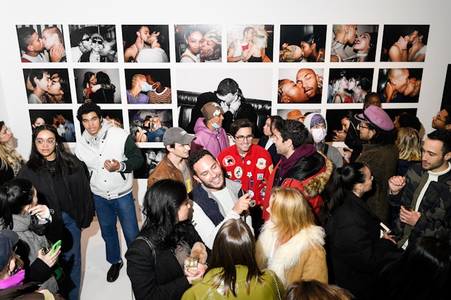 Guests celebrate the opening of photographer Tyrell Hampton's gallery show.