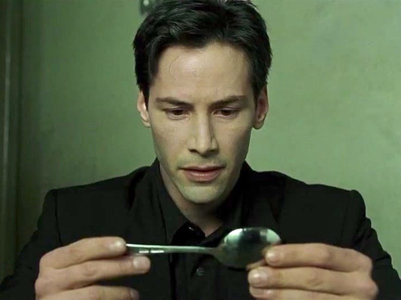 Keanu Reeves as Neo in Matrix attempting to bend a spoon 