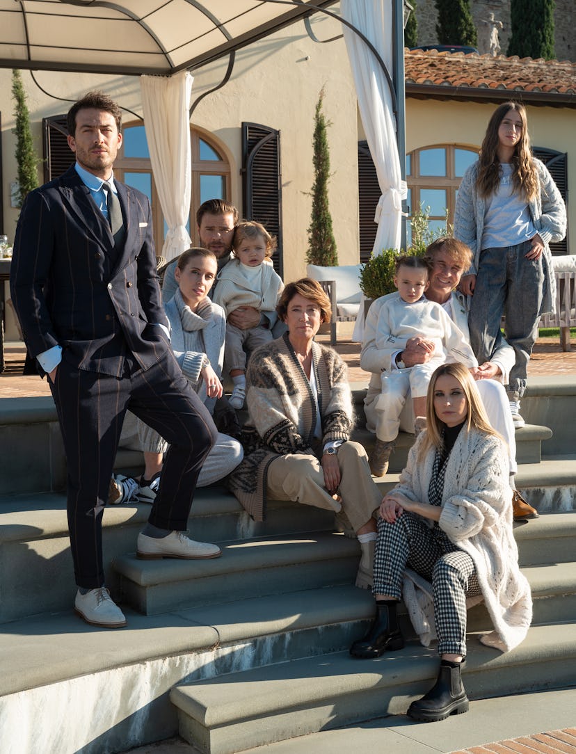 The entire Cucinelli family posing in their own clothes and accessories in a Christmas family photo