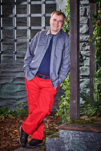 Simon Gregson poses in the castle wearing his camp clothes