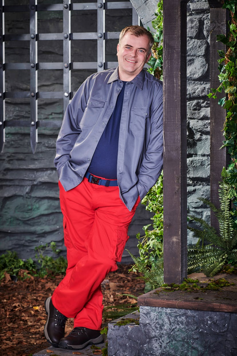 Simon Gregson poses in the castle wearing his camp clothes