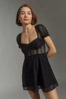 Model wearing Urban Outfitters black, lace, mini dress.