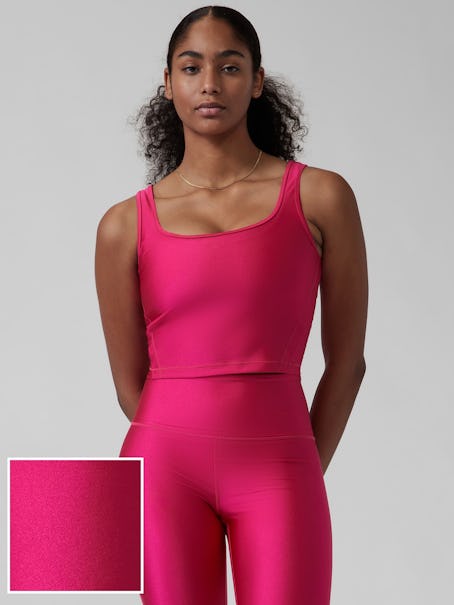 Model wearing a shiny, pink top from Athleta's Black Friday sale.