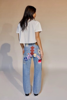 Model in Urban Outfitters jeans with patches.