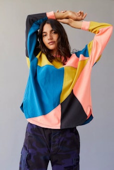 Model in a vibrant, long sleeved t-shirt from Urban Outfitters.