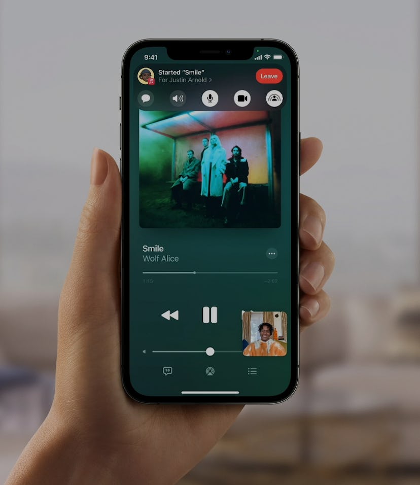 Person holding an iPhone using SharePlay with Spotify.