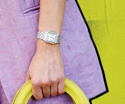 A woman's vintage silver watch, going well with a purple coat and a yellow bag