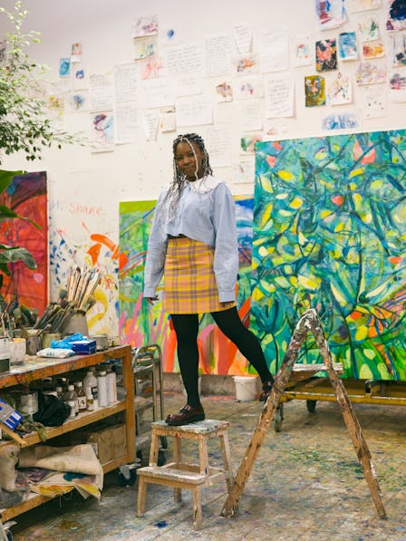 Artist Jadé Fadojutimi with paintings in her studio.