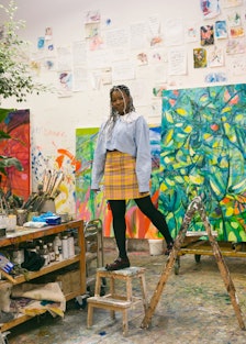 Artist Jadé Fadojutimi with paintings in her studio.