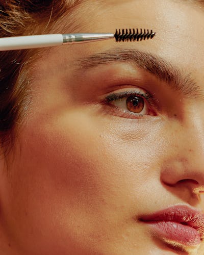 woman brushing brows