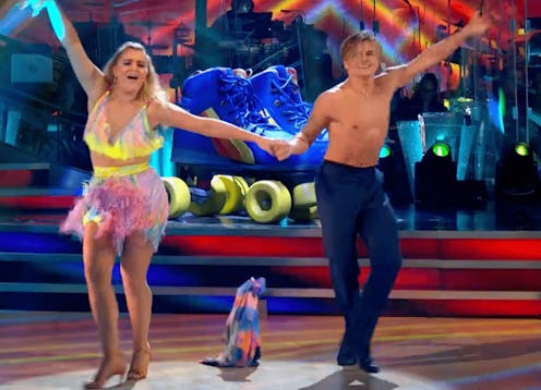 Strictly contestant Tilly Ramsey and pro dancer Nikita Kusmin dance with arms aloft as his multicolo...
