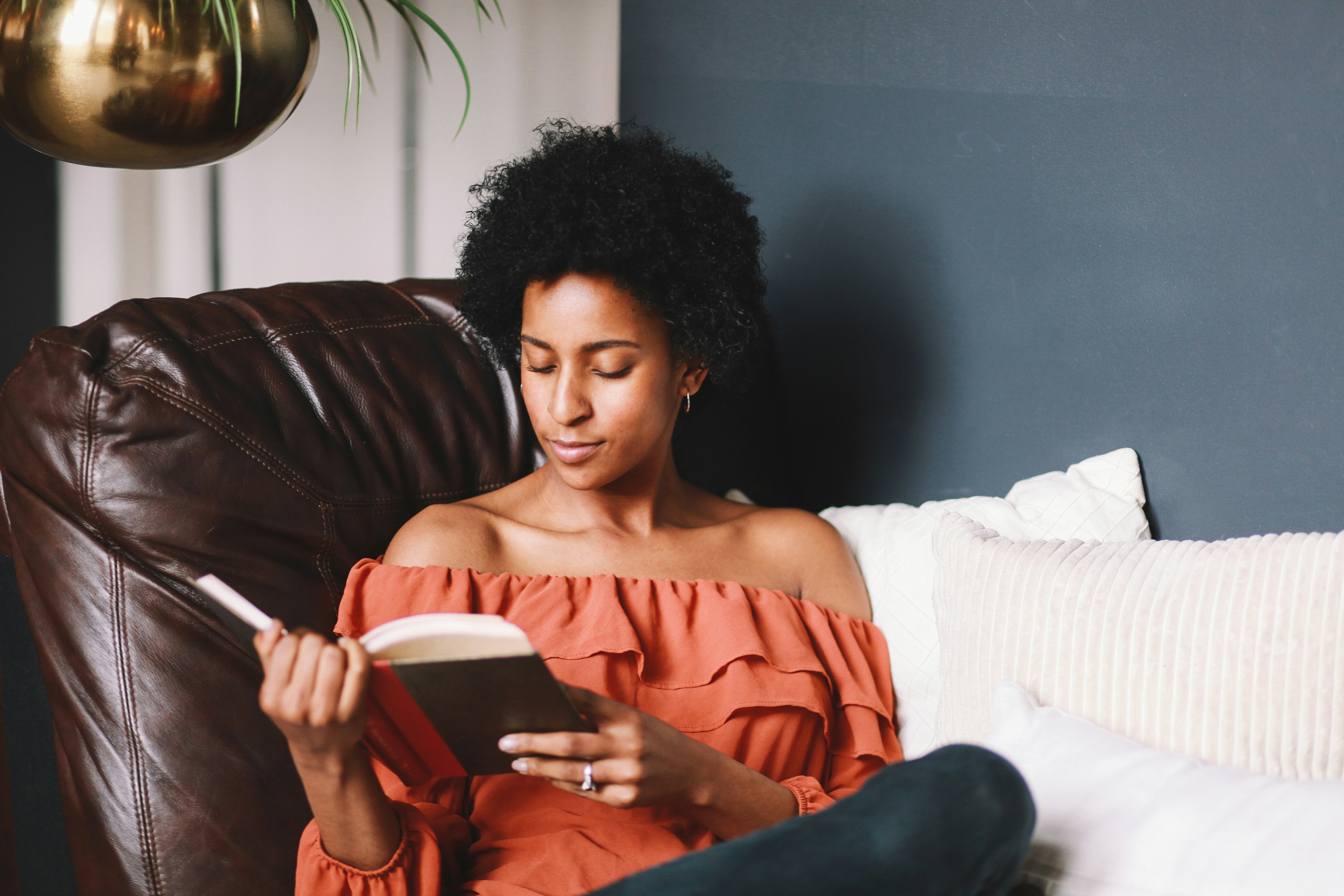 Young woman relaxing, reading a book.