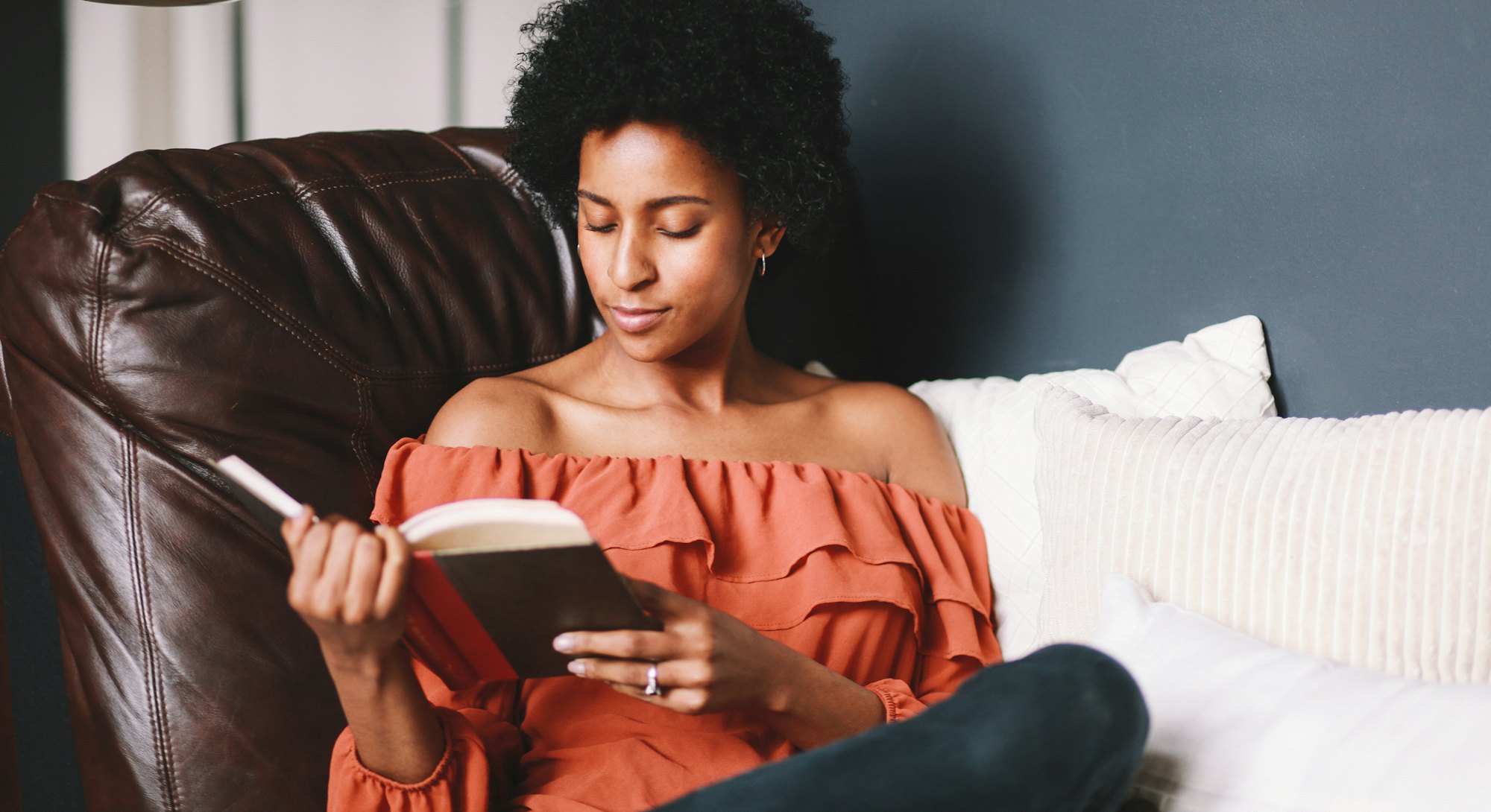 Young woman relaxing, reading a book.