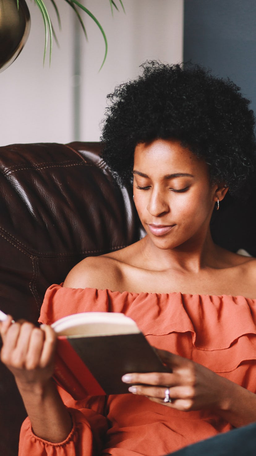 Young woman relaxing, reading a book.