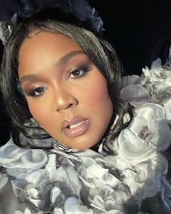 Lizzo in grey eyeshadow taking selfie