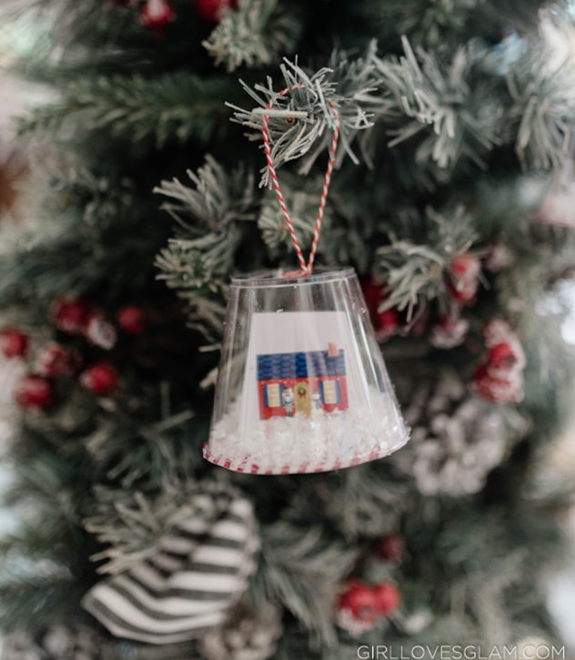 Kids can make this DIY snow globe ornament from a plastic cup.