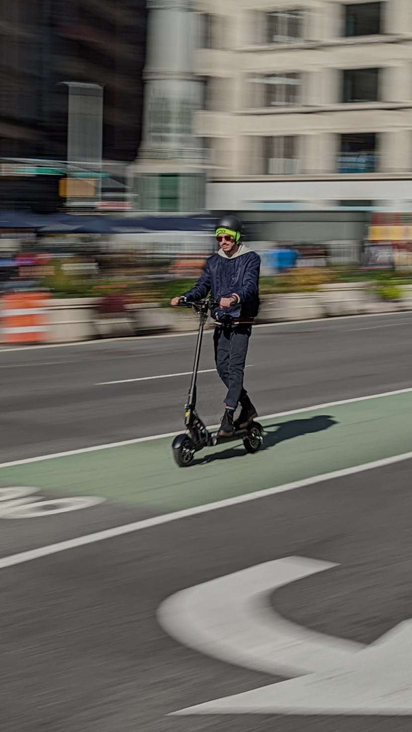 A man riding Apollo Ghost electric scooter. EV. Electric vehicles. EVs. e-scooter