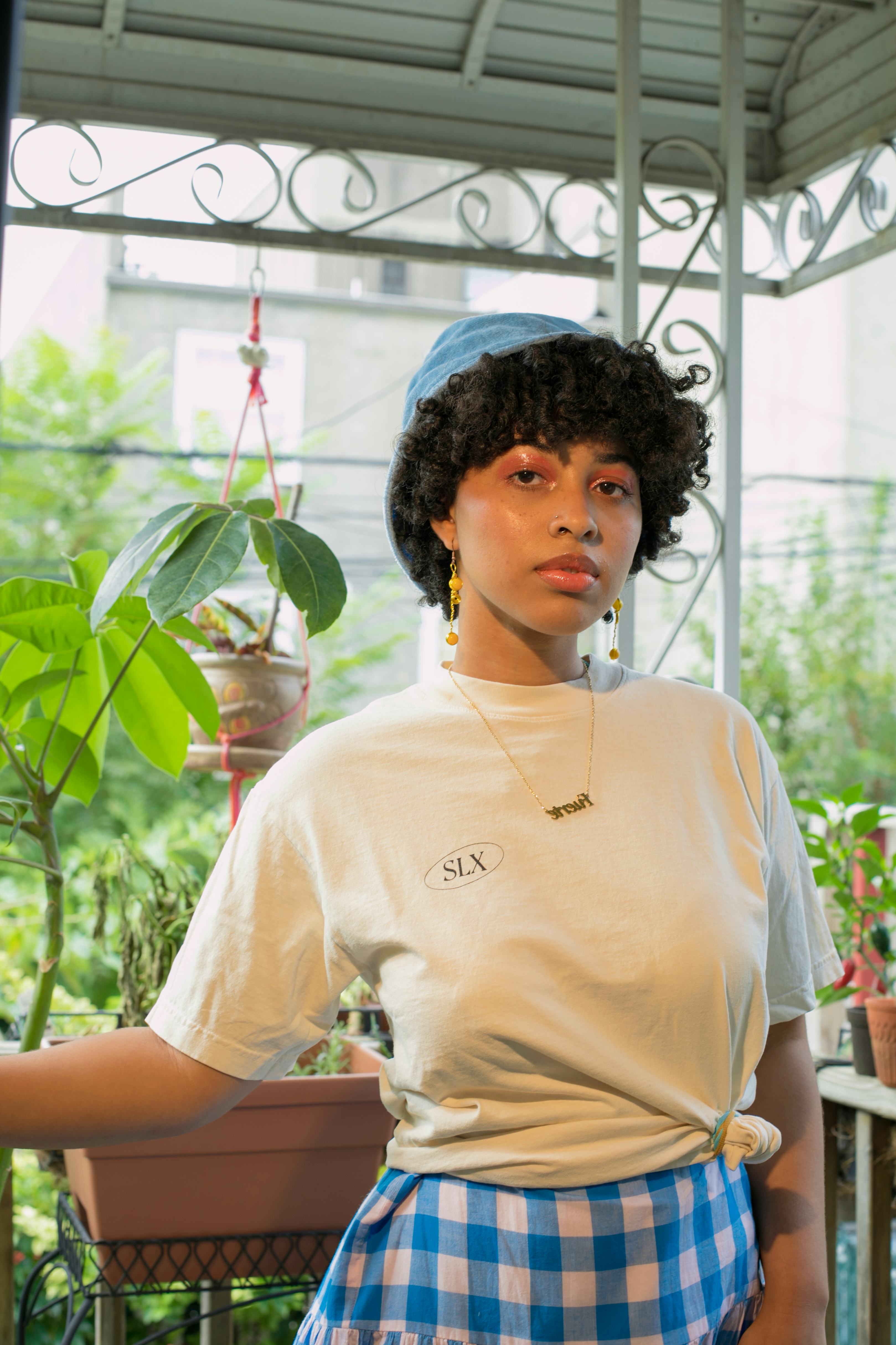 Brittany posing in a white shirt and a blue and white skirt