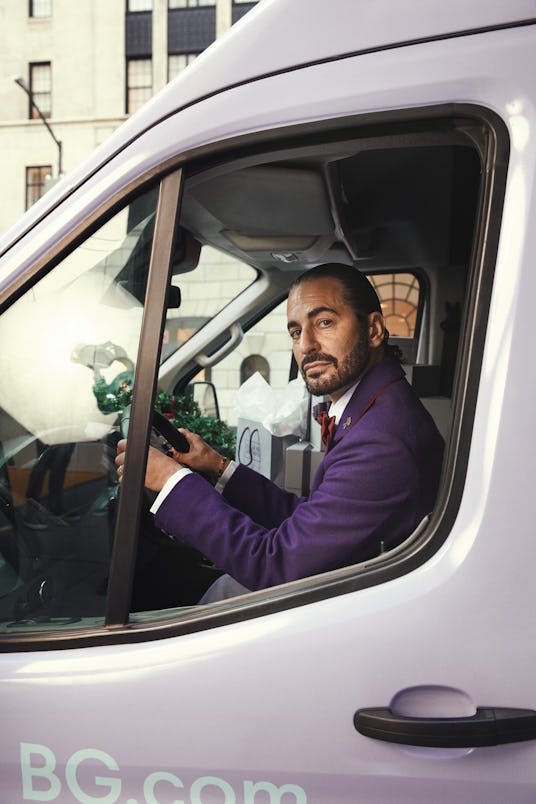 Designer Marc Jacobs sitting behind a wheel of a grey van