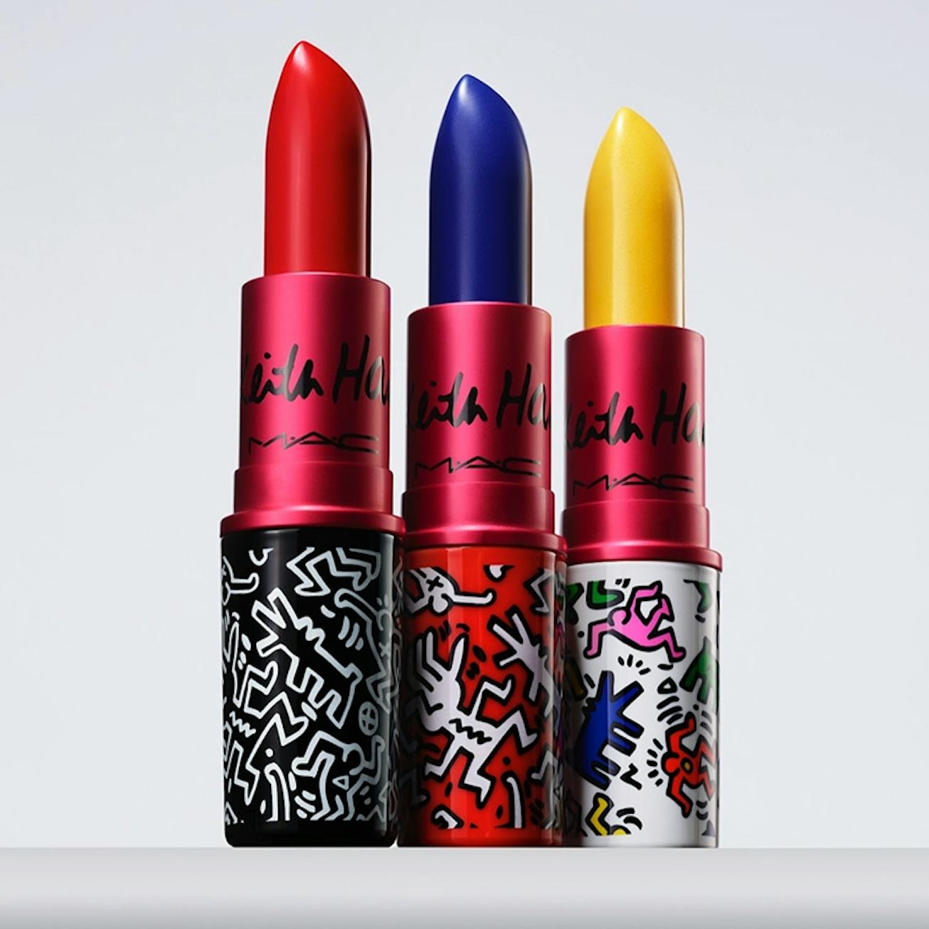 Red, blue and yellow MAC’s Viva Glam x Keith Haring Lipsticks in front of the white background