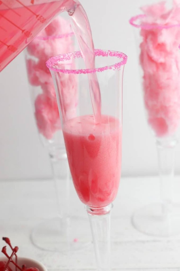 Champagne flutes with pink drink and pink cotton candy