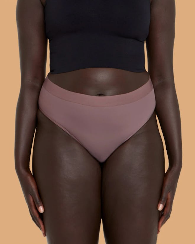 Image of a woman in rose-colored Thinx underwear. 