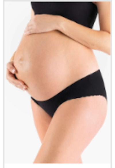 Image of a pregnant person wearing a pair of Belly Bandit underwear. 