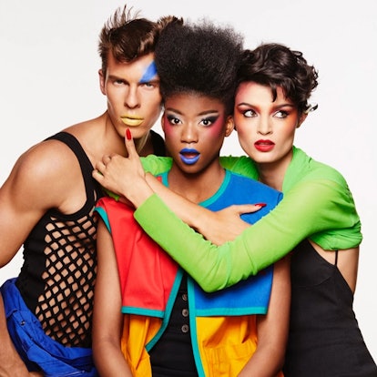 Two female and one male model wearing MAC’s Viva Glam x Keith Haring Lipsticks while posing in color...