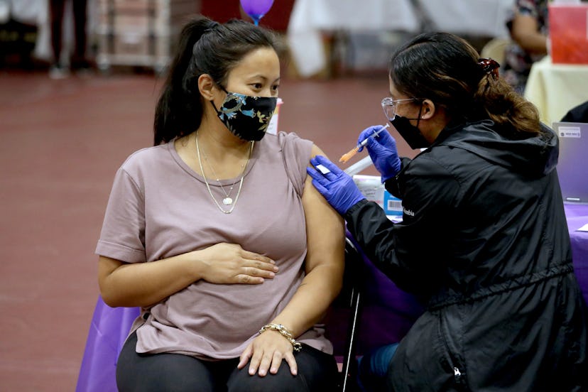Nicole Fahey, of Altadena, six months pregnant, receives a Pfizer vaccination booster shot on Wednes...